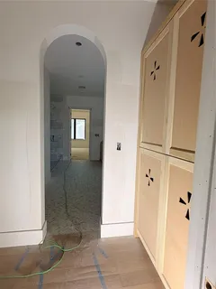 an empty room with wooden floor and window