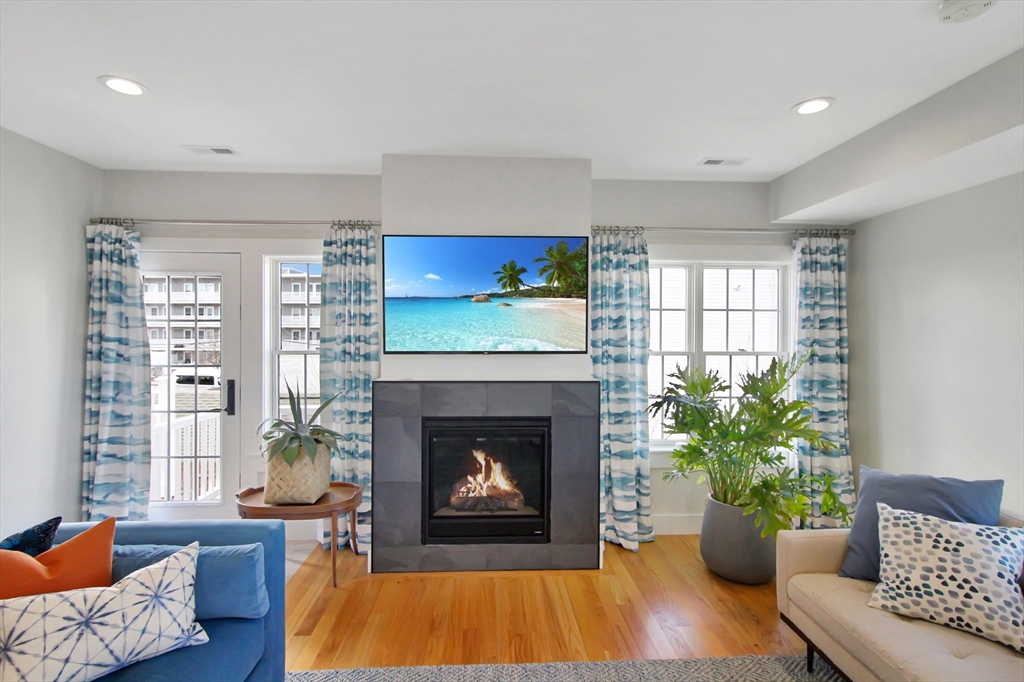 10 Berkley Road, Unit A Hull, MA 02045 - Photo 2 of 25 a living room with furniture and a fireplace