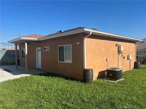 a backyard of a house with table and chairs