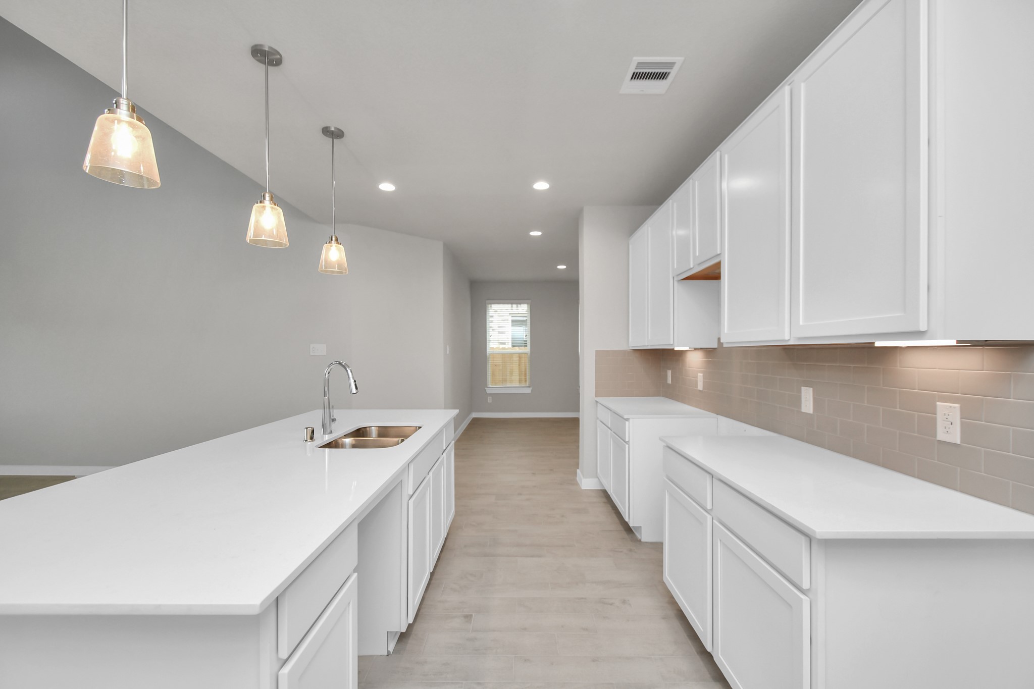 15111 Statice Trail Houston, TX 77044 - Photo 4 of 35 Discover another perspective of this stunning kitchen, generously appointed with an abundance of counter space. Sample photo of completed home with similar plan. As built color and selections may vary.