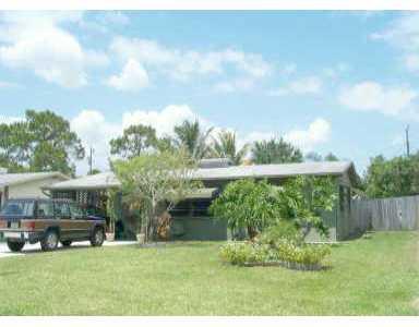 a view of house with backyard outdoor seating and green space