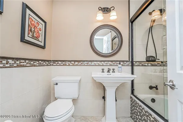 a bathroom with a sink a mirror and a toilet