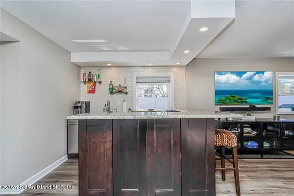 a kitchen with stainless steel appliances granite countertop a sink a microwave a stove and refrigerator