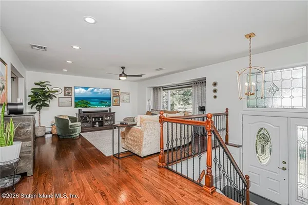 a living room with furniture a fireplace and wooden floor