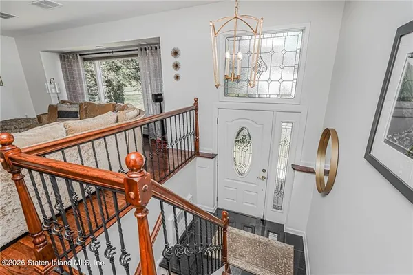 a view of entryway and hall with wooden floor