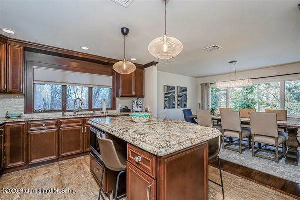 a kitchen with granite countertop center island and windows