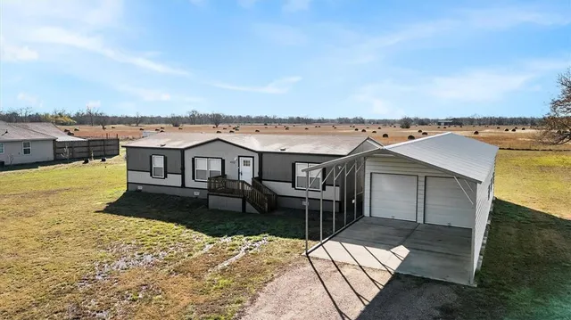 an aerial view of a house with a yard