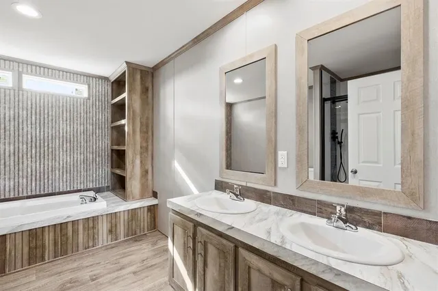 a bathroom with a granite countertop sink double vanity and a mirror