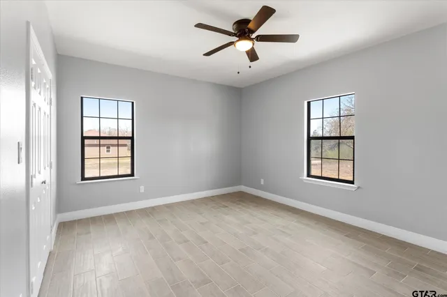 wooden floor in an empty room with a window