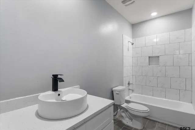 a bathroom with a sink toilet and bathtub