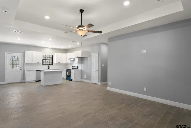 a view of a kitchen with a sink and chandelier