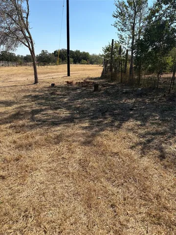 a view of a yard with a tree