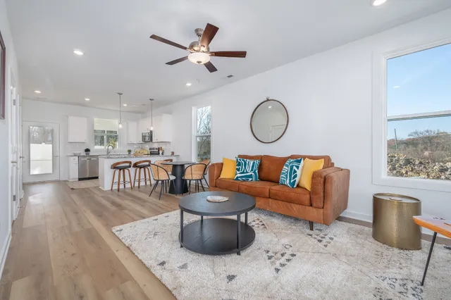 a living room with furniture and kitchen view