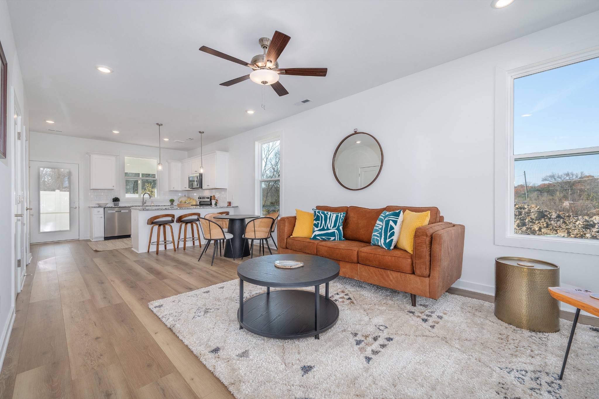 a living room with furniture and kitchen view