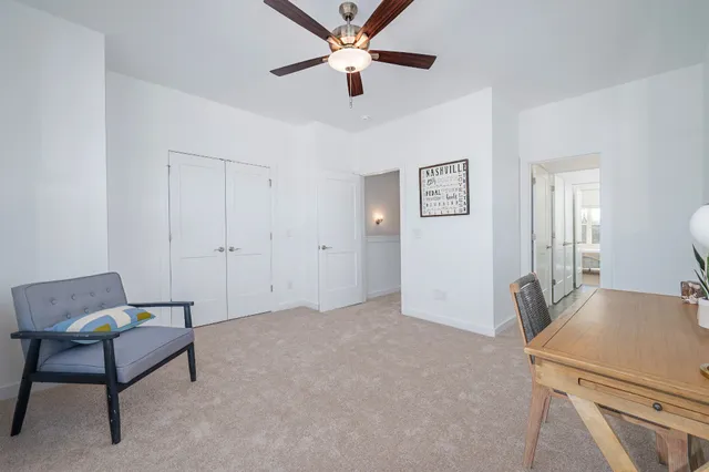 a view of workspace with furniture and a ceiling fan