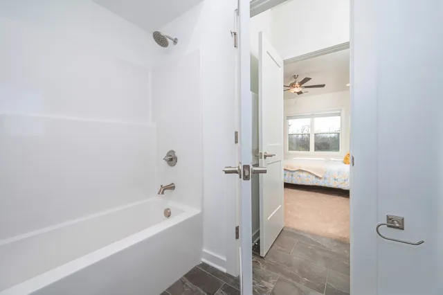 a bathroom with a tub and a shower