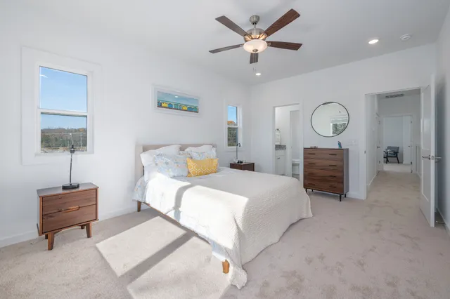 a bedroom with a bed and a lamp on dresser