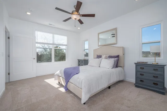 a bedroom with a large bed and a window