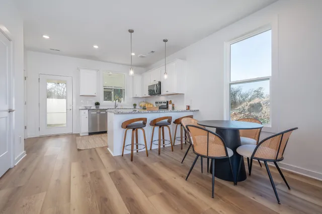 a view of a dining room with furniture and wooden floor