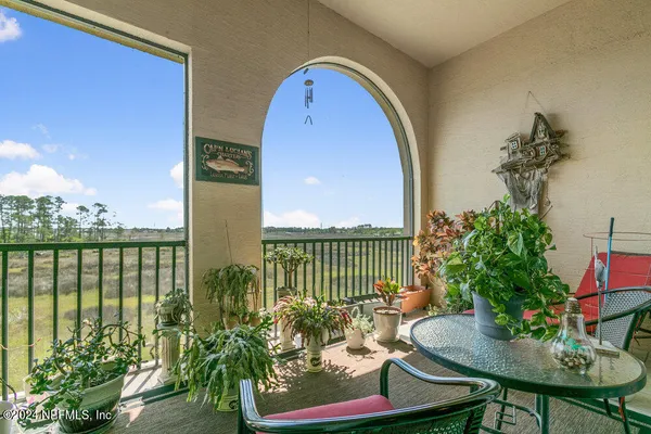 a view of a balcony with furniture