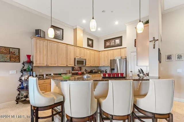 a view of a dining room with furniture and chandelier