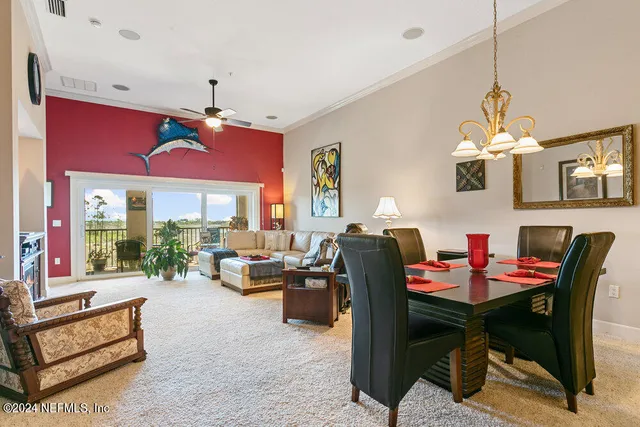 a view of a dining room with furniture and chandelier