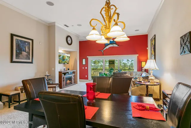 a kitchen with stainless steel appliances granite countertop a stove and a view of living room