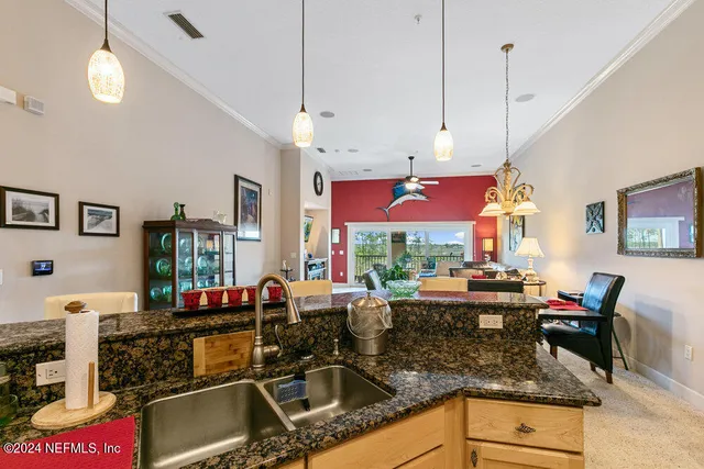 a living room with furniture a window and a flat screen tv