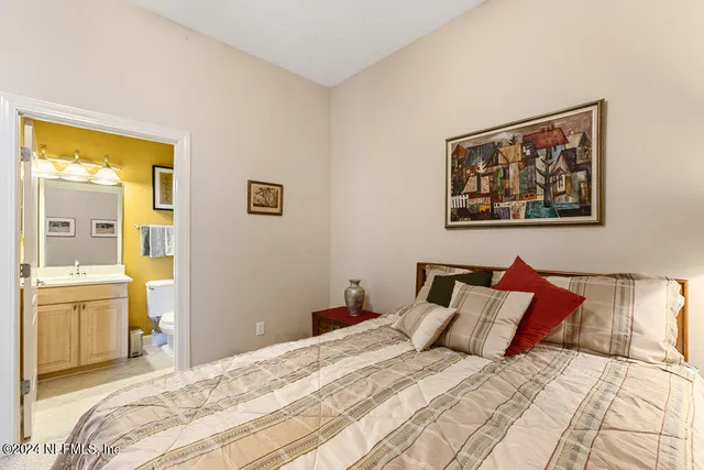 a bathroom with a sink a toilet a mirror a bathtub and shower