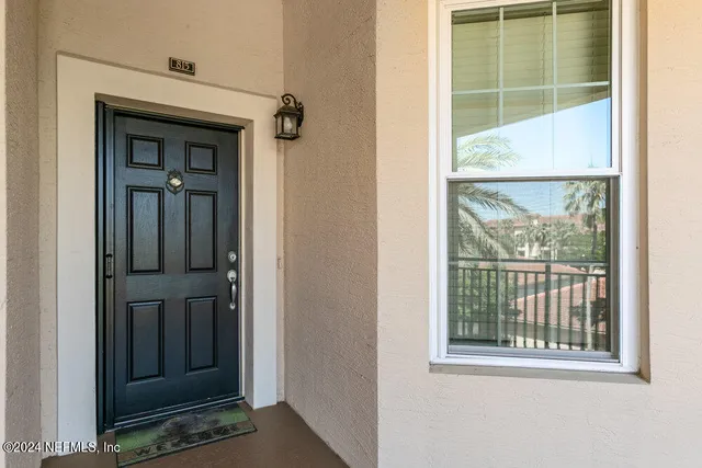 a view of living room with furniture and mirror