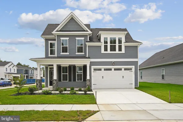 a view of a big house with a big yard and large trees