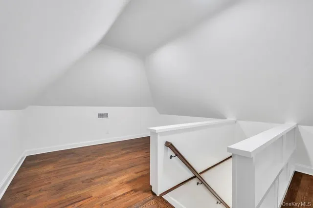 a view of an empty room and wooden floor
