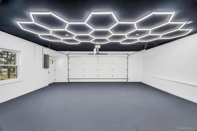 a front view of a house with garden and trees