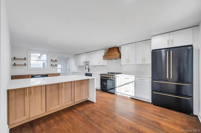 a view of empty room with wooden floor and fireplace