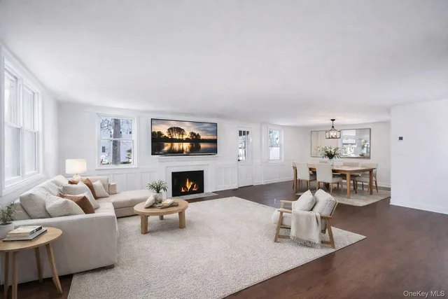 a kitchen with a refrigerator a stove a sink and a dining table with wooden floor