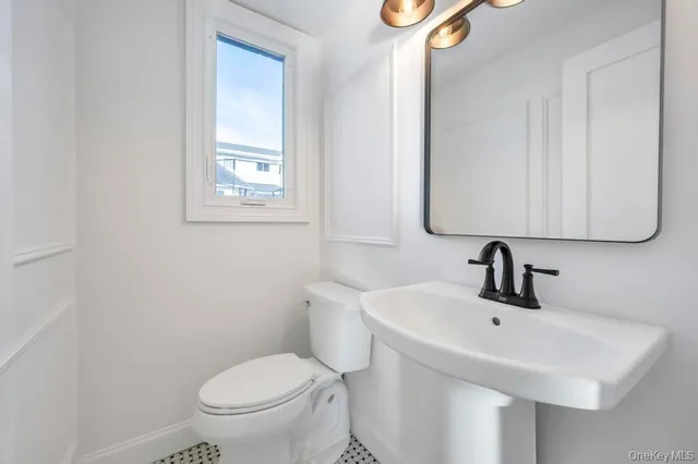 a living room with furniture and a ceiling fan