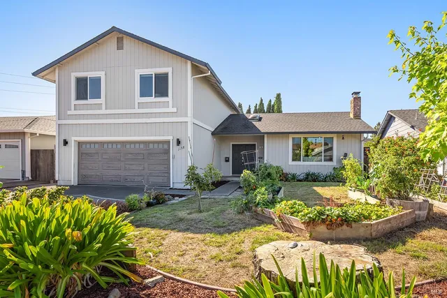 a front view of a house with a garden