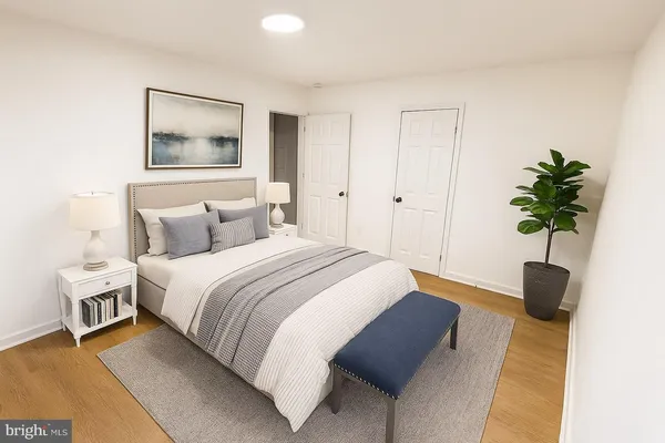 a bedroom with a bed and a potted plant