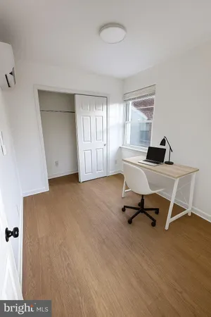 a view of a workspace with furniture and a window