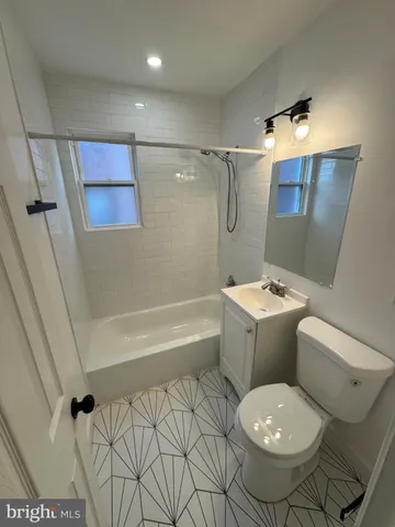 a bathroom with a toilet sink and shower