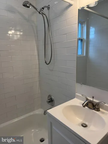 a bathroom with a sink a shower and a mirror