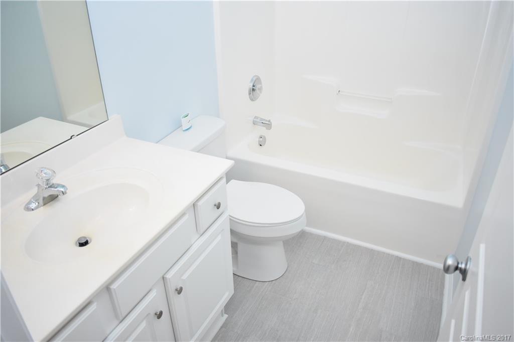 224 Dawn Mist Lane Fort Mill, SC 29708 - Photo 11 of 16 a bathroom with a white toilet and a sink