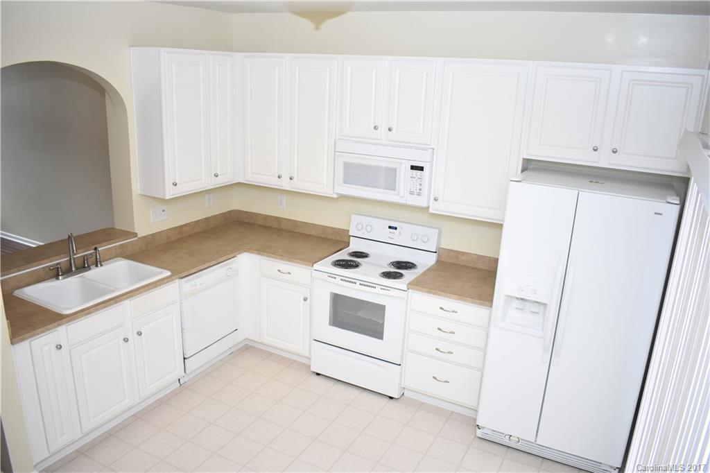 224 Dawn Mist Lane Fort Mill, SC 29708 - Photo 4 of 16 a kitchen with white cabinets and white appliances