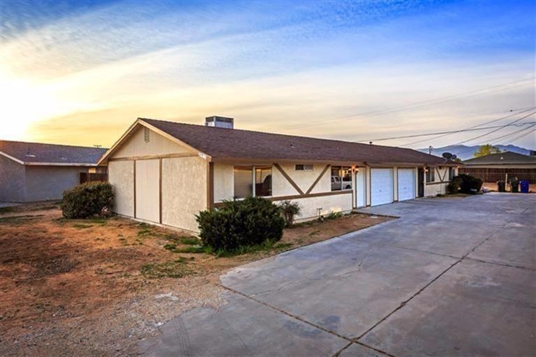 20953 Sioux Road Apple Valley, CA 92308 - Photo 1 of 1 a front view of a house with a yard and garage