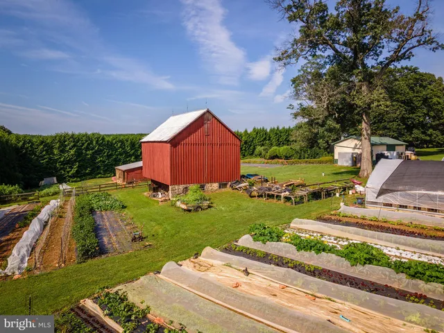 a kitchen with stainless steel appliances a stove top oven a sink a refrigerator and cabinets