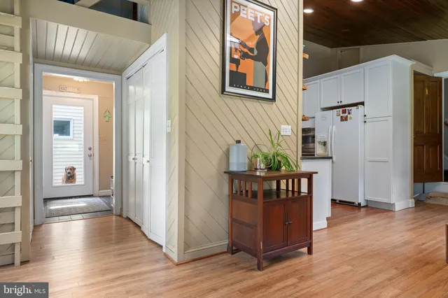 a bedroom with a bed and a bookshelf with wooden floor