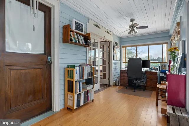 a view of a patio with table and chairs potted plants with wooden floor and fence