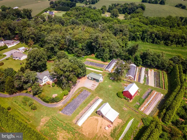 an aerial view of a house with swimming pool garden and mountain view