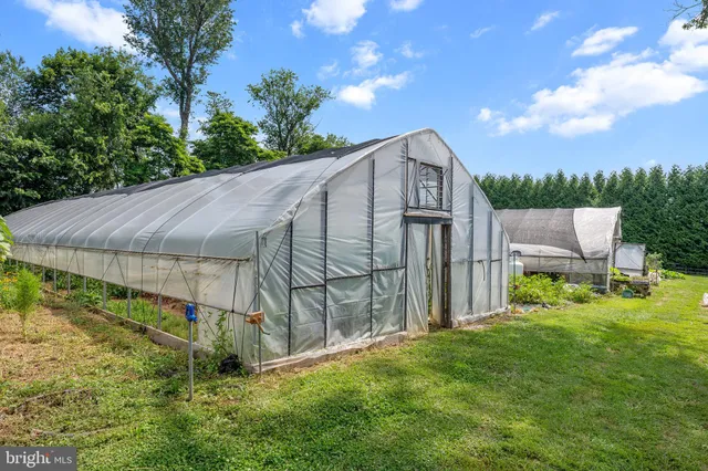 a view of a house with a wooden deck and furniture