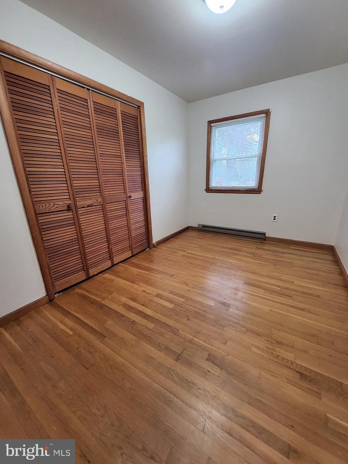 415 View Town Road Amissville, VA 20106 - Photo 14 of 19 a view of an empty room with wooden floor and a window